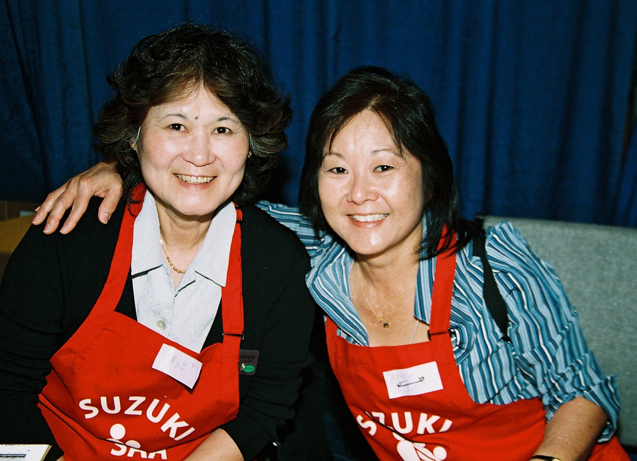 Rosemay Fangyen, convention staff, and Deb Yamashita, SAA staff in their red SAA aprons.