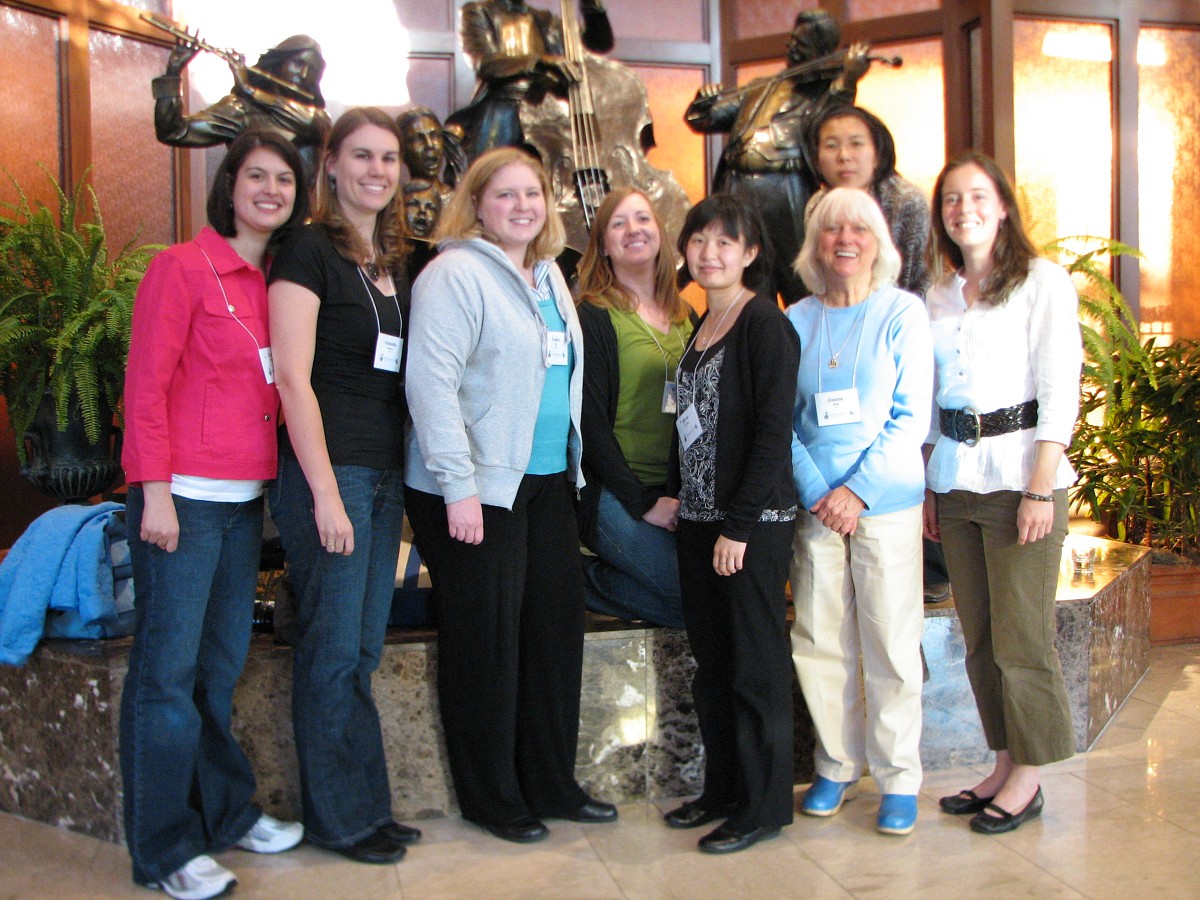 Joanne Bath and ECU past and current long-term training program participants with the Hilton lobby statues.