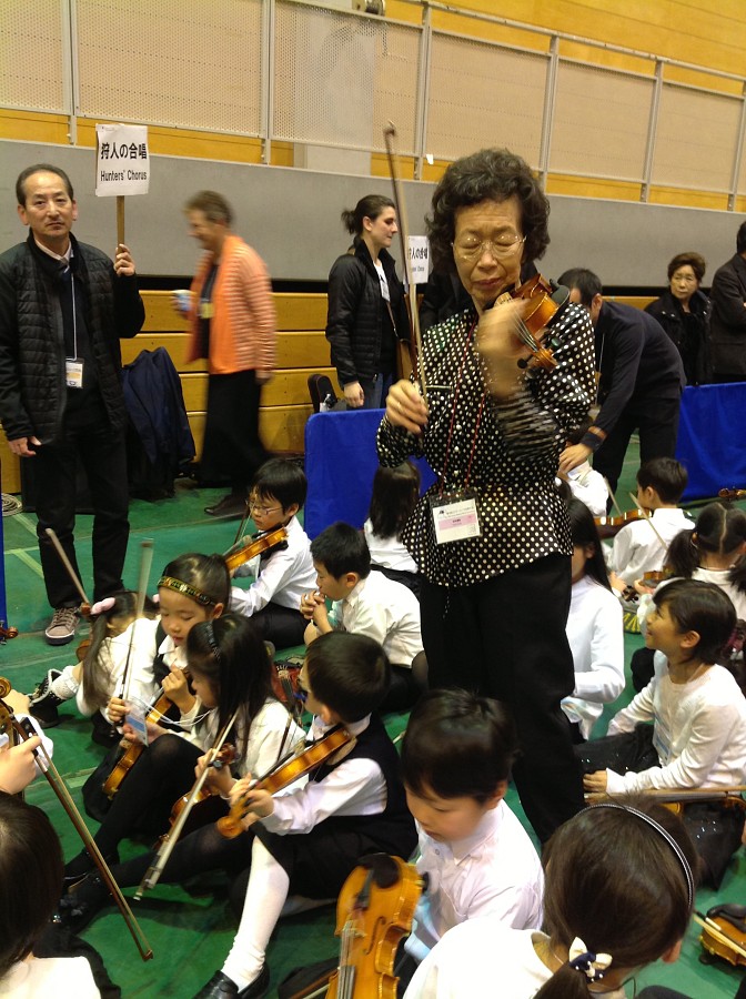 Mihoko Hirata tuning students as they get ready for the Final Concert and Closing Ceremonies