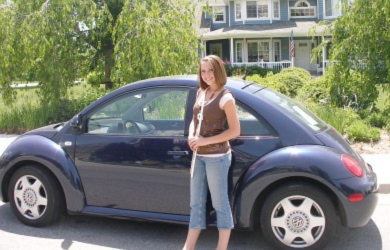 Helen McGarr and her blue Volkswagen Beetle