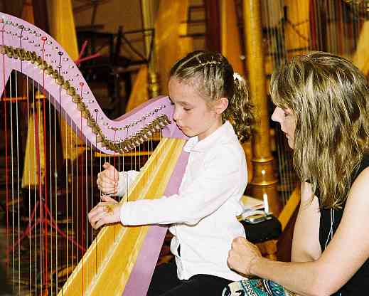 Jill Whitman with young harp student and pink harp.