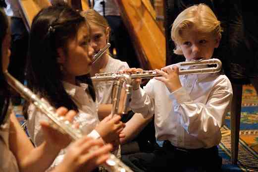 Flute choir students warm up for their performance at the 2008 SAA Conference