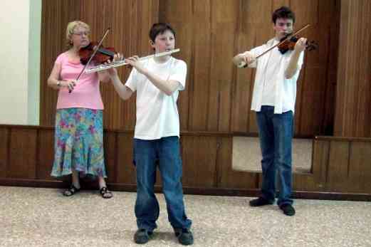 Carmen Wise, Thomas, and Jeffrey playing Child of the Poor