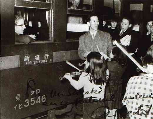 Shinichi Suzuki and students play at a railroad station for Alfred Cortot