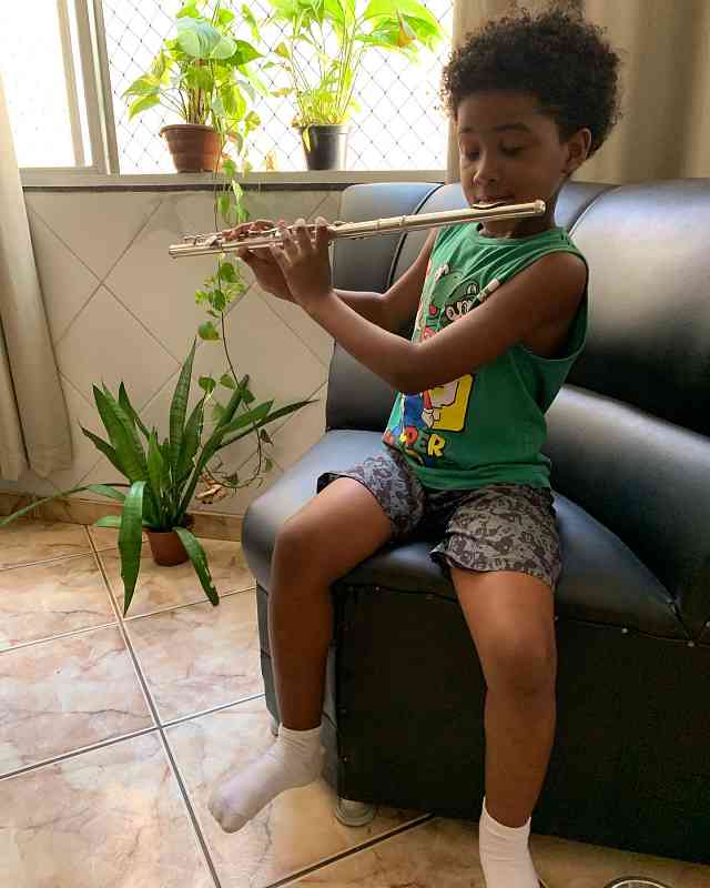 Murilo practicing flute at home.