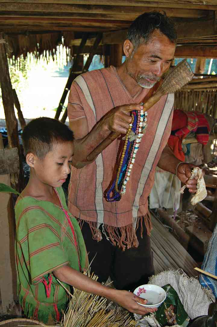 Karen father and son harvest ritual, Mae Hong Son, Thailand, 2008