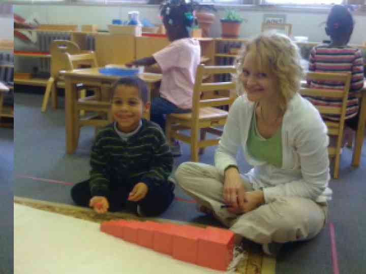 Montessori student with lead teacher Lisa Vukmirovich building pink tower blocks