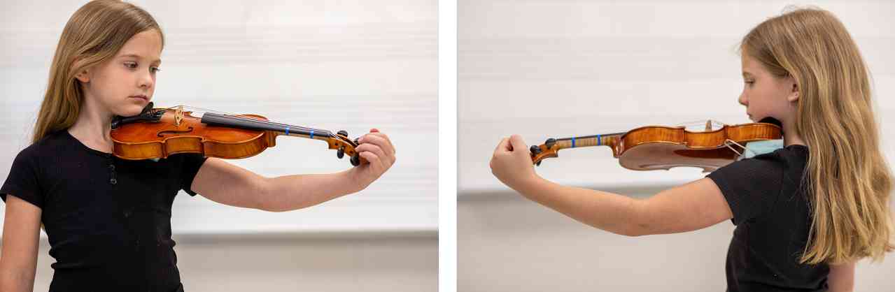Figures 1 and 2. An appropriately sized violin. The student can comfortably curve their left hand around the scroll while maintaining a bend in the el
